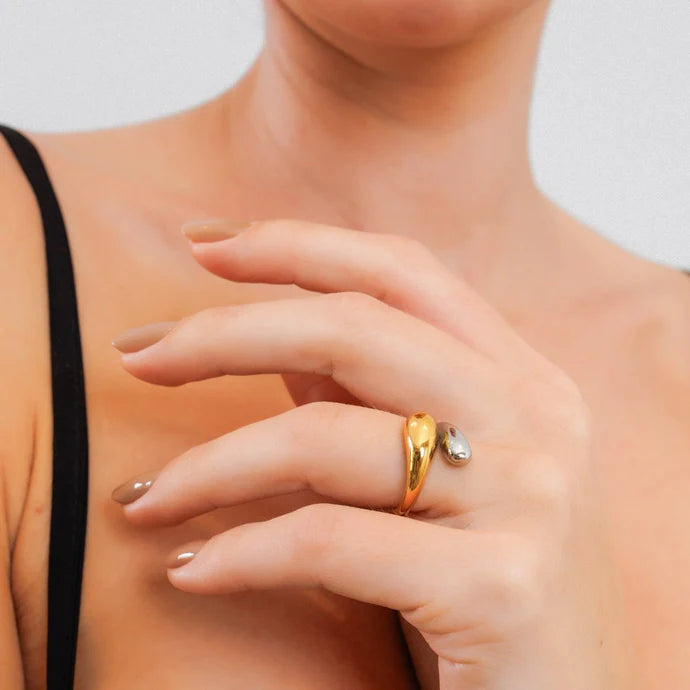 Adjustable teardrop ring with a mix of gold and silver plating.